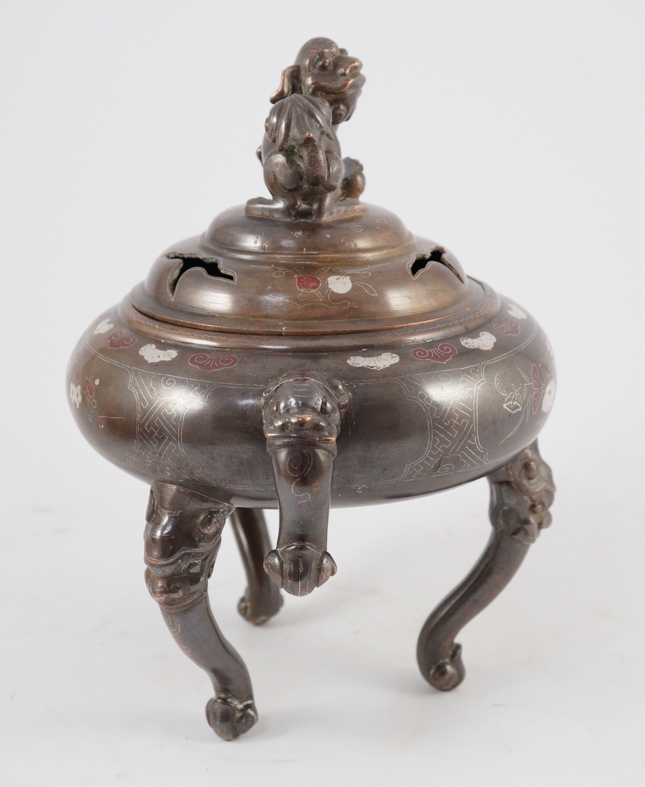 A Vietnamese silver inlaid bronze tripod censer and cover, 19th century, 24cm high, 24cm wide